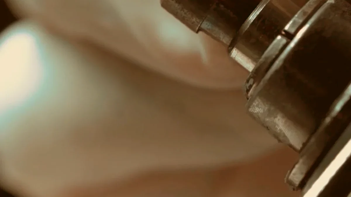 Close-up of metal processing equipment against a softly blurred background