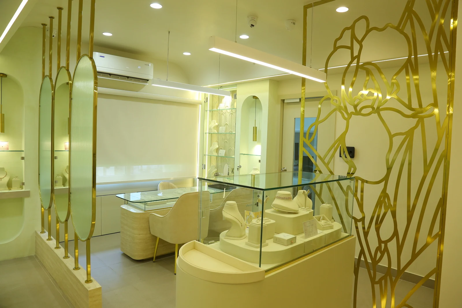 The Aureva showroom interior, with glass display counters and gold floral screens